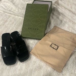 Gucci women’s rubber slide sandals.